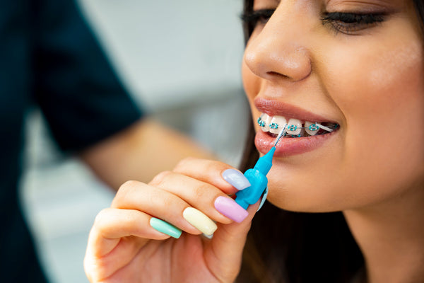 Young, trendy lady with braces using an interdental brush Marion Nowak Marion Nowak 3:29 PM Feb 17 Alt text: A happy woman shows off her sparkly, white teeth.